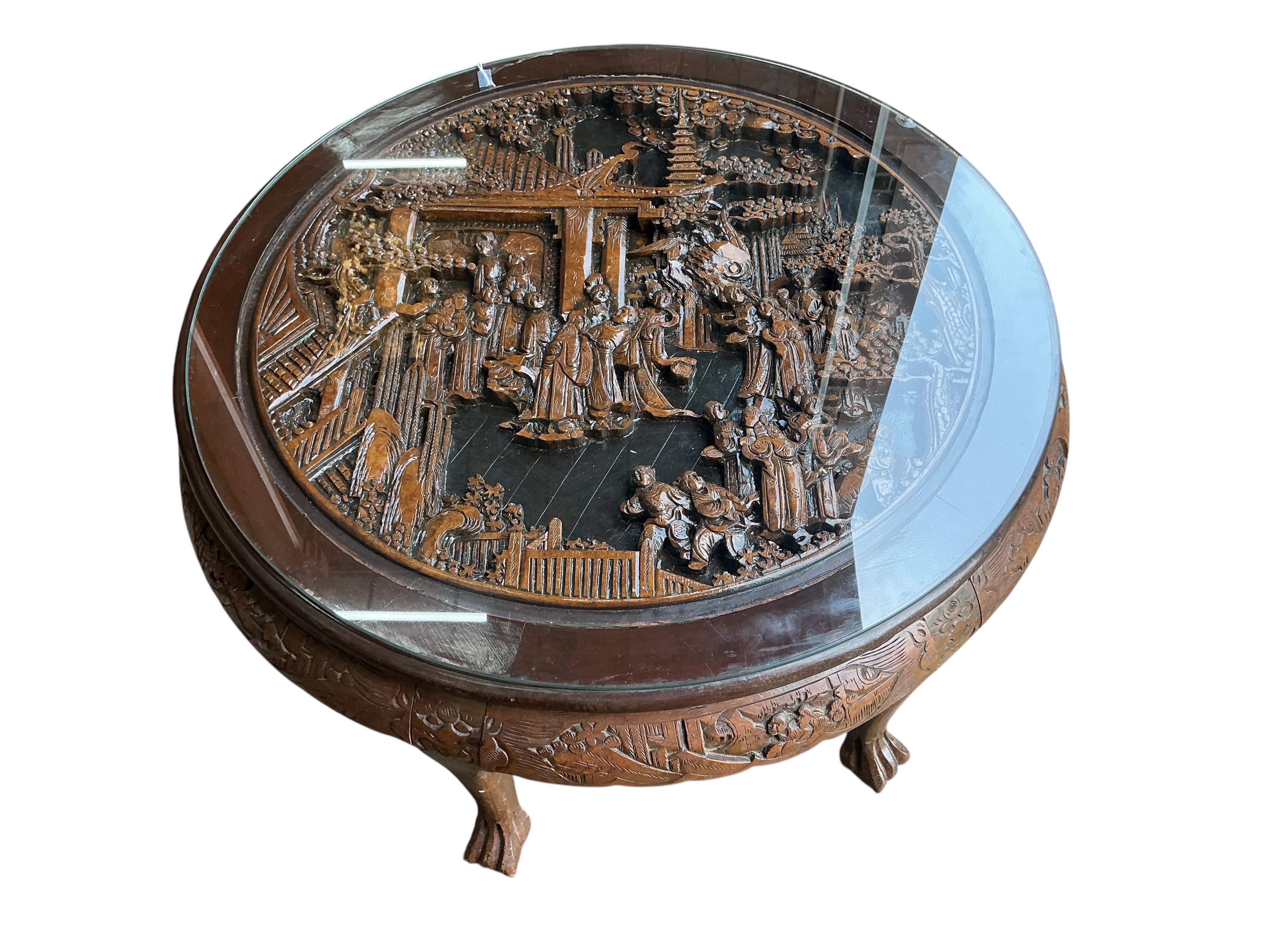 A Chinese carved hardwood circular low table, diameter 110cm, height 50cm and five stools